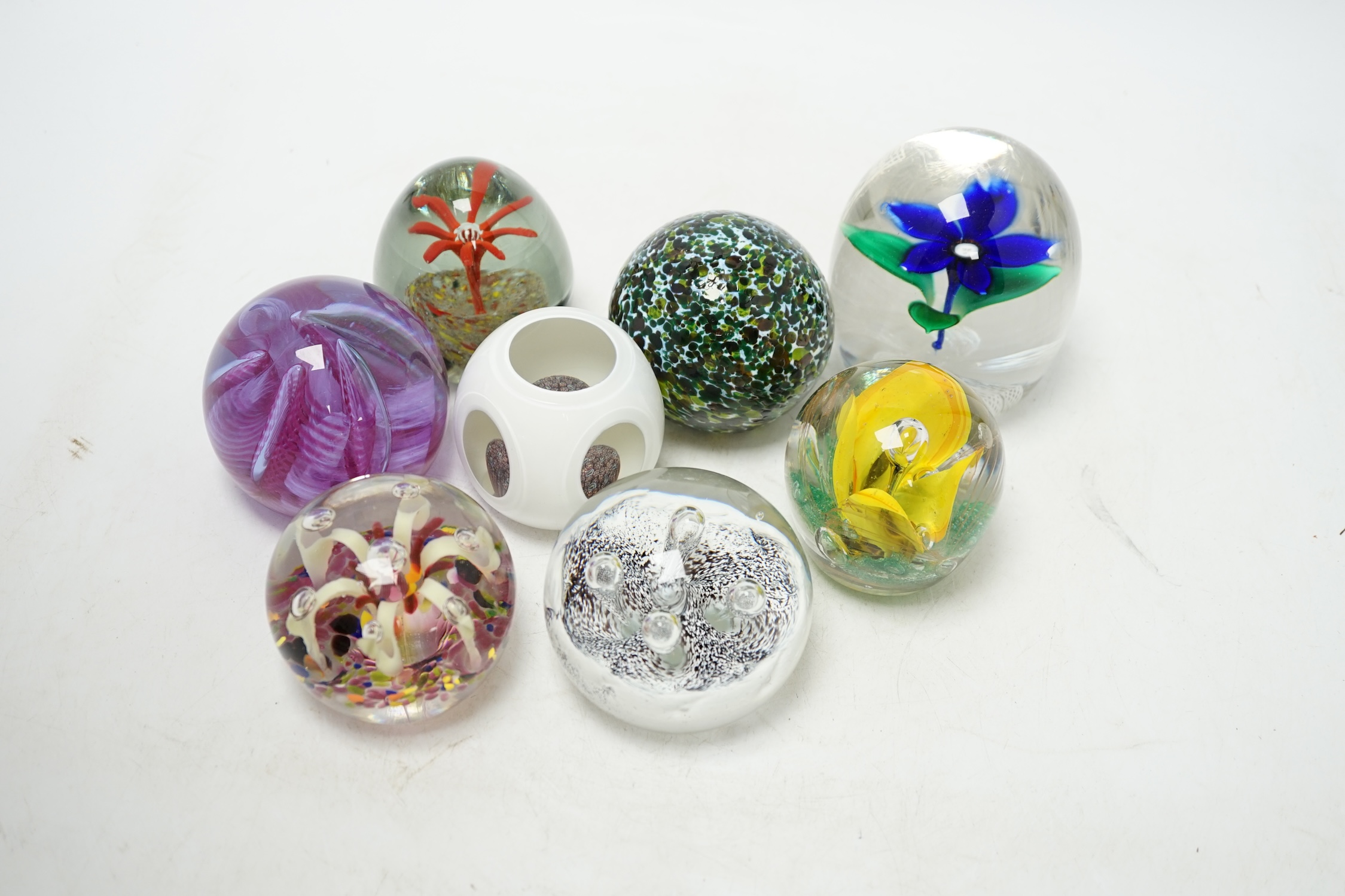 A group of eight various glass paperweights, tallest 10cm. Condition - fair to good